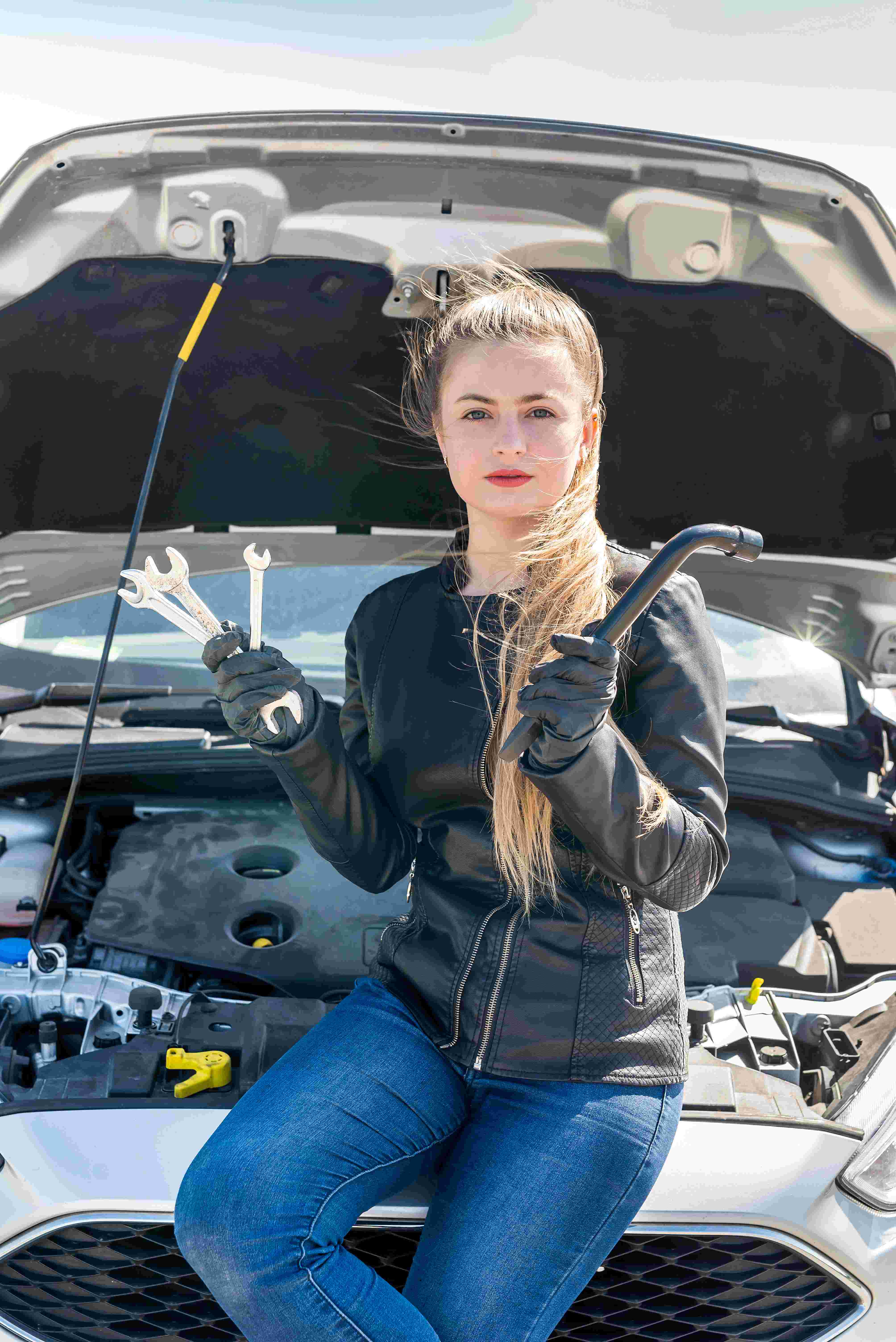 woman driver with wrenches open car hood_11zon